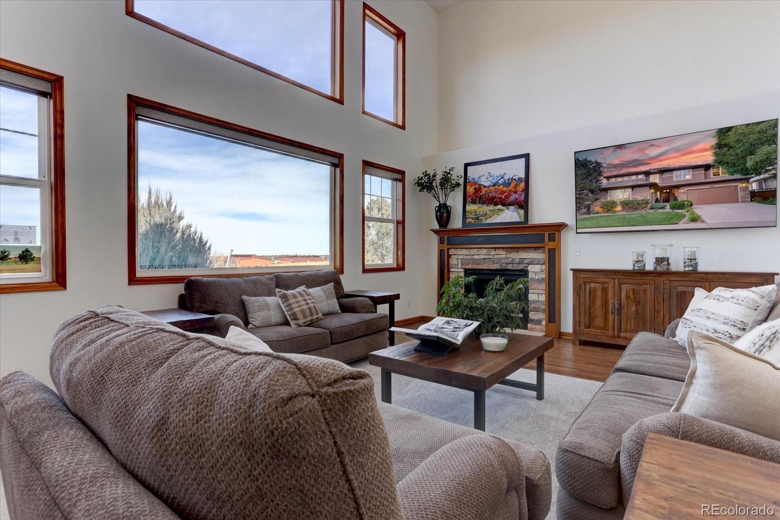 2795 Rockbridge Circle Highlands Ranch, CO 80129 - Photo 18 of 48 a living room with fireplace furniture and a window