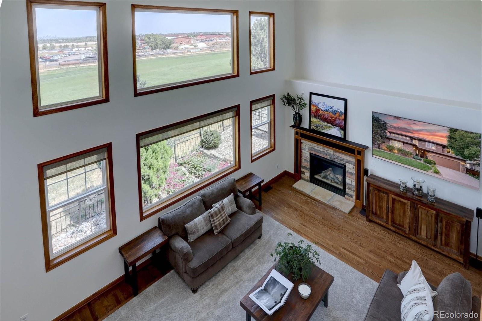 2795 Rockbridge Circle Highlands Ranch, CO 80129 - Photo 21 of 48 a living room with furniture a flat screen tv and a window