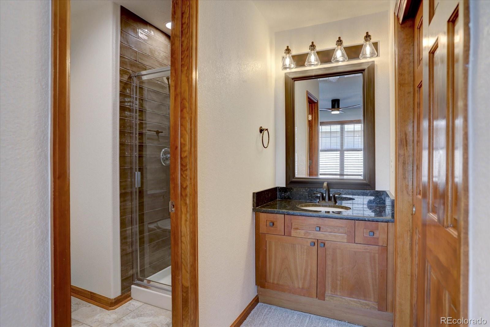 2795 Rockbridge Circle Highlands Ranch, CO 80129 - Photo 36 of 48 a bathroom with a granite countertop sink and a mirror