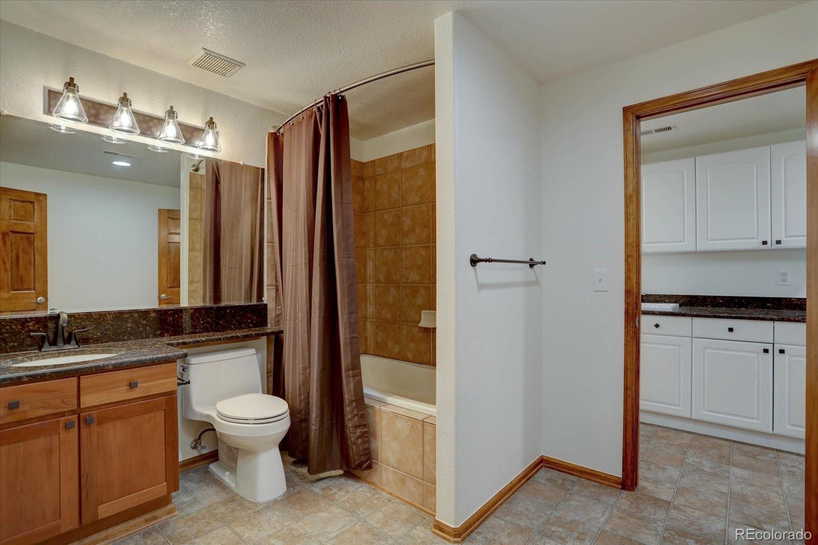 2795 Rockbridge Circle Highlands Ranch, CO 80129 - Photo 39 of 49 a bathroom with a granite countertop sink toilet and shower