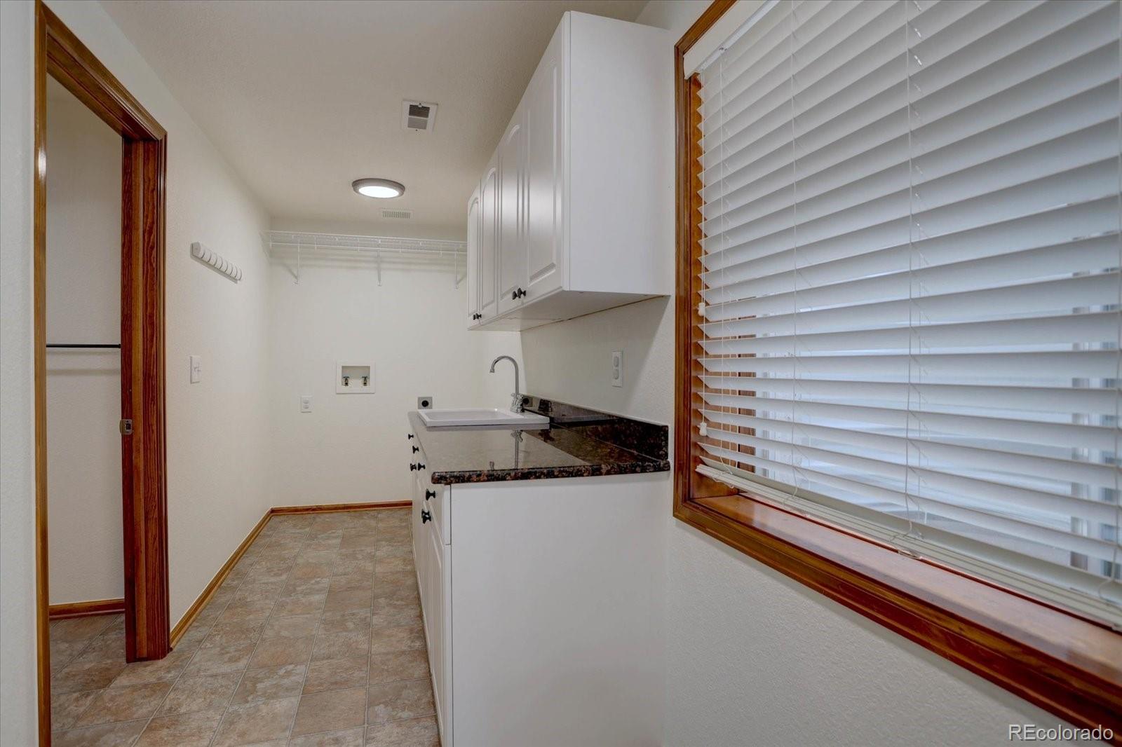 2795 Rockbridge Circle Highlands Ranch, CO 80129 - Photo 40 of 49 a view of a kitchen with a sink and cabinets
