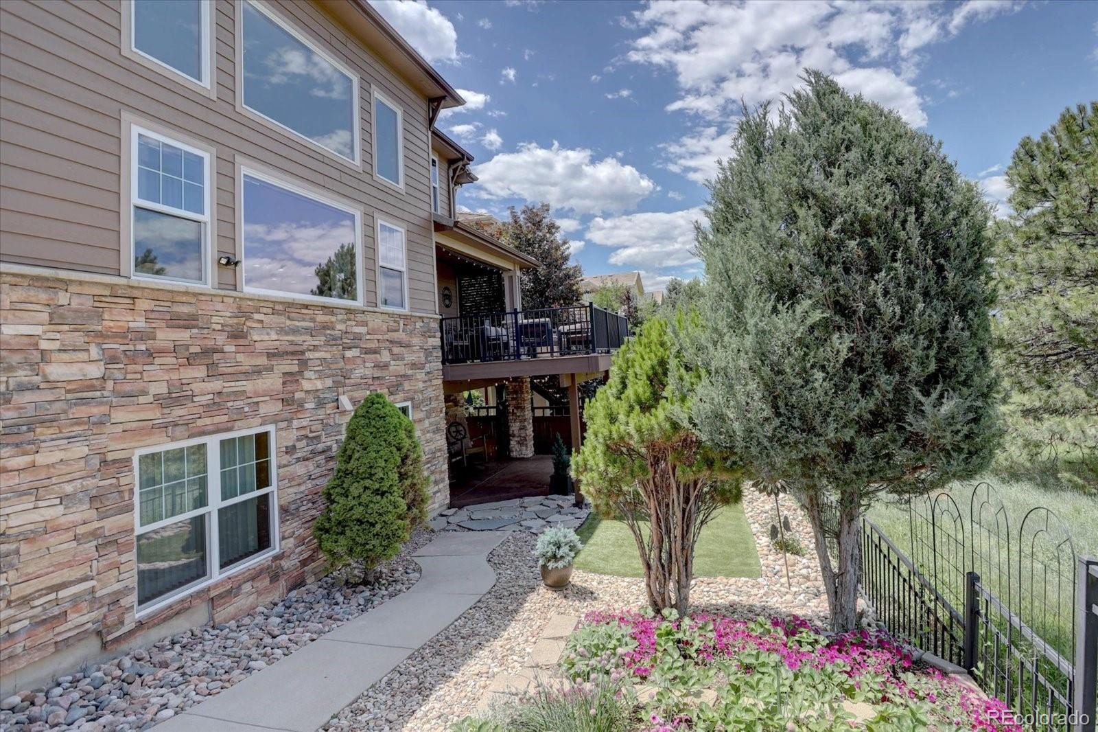 2795 Rockbridge Circle Highlands Ranch, CO 80129 - Photo 45 of 48 a flower garden in front of a building