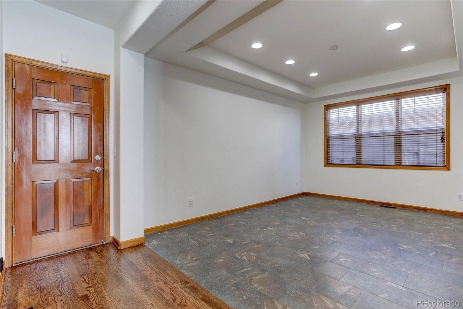 2795 Rockbridge Circle Highlands Ranch, CO 80129 - Photo 8 of 48 an empty room with wooden floor and windows