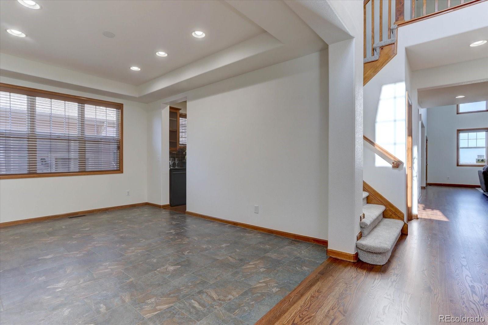 2795 Rockbridge Circle Highlands Ranch, CO 80129 - Photo 9 of 48 an empty room with wooden floor and windows