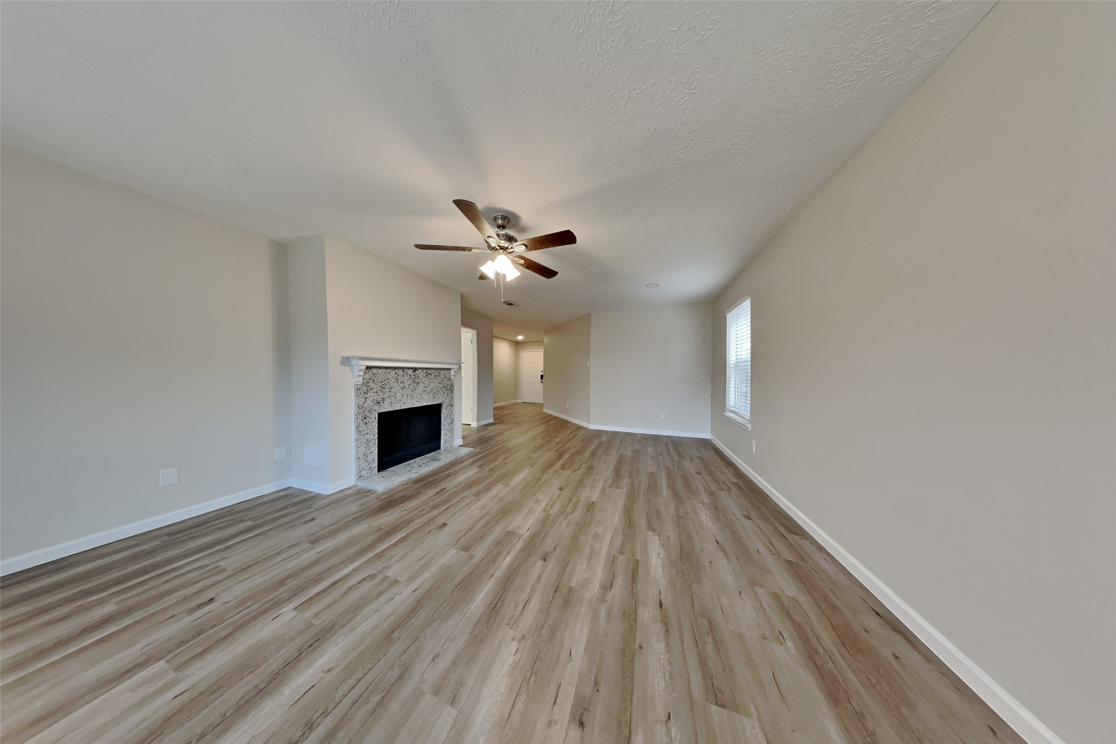 30806 Melita Drive Spring, TX 77386 - Photo 3 of 18 a view of empty room with wooden floor and fireplace