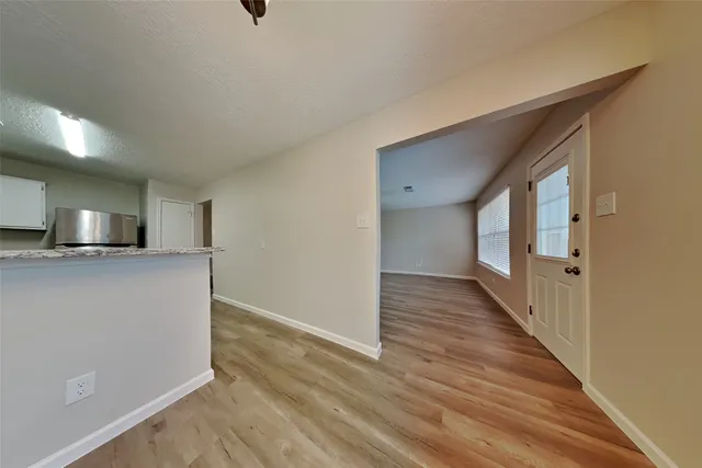 a view of a kitchen from a hallway