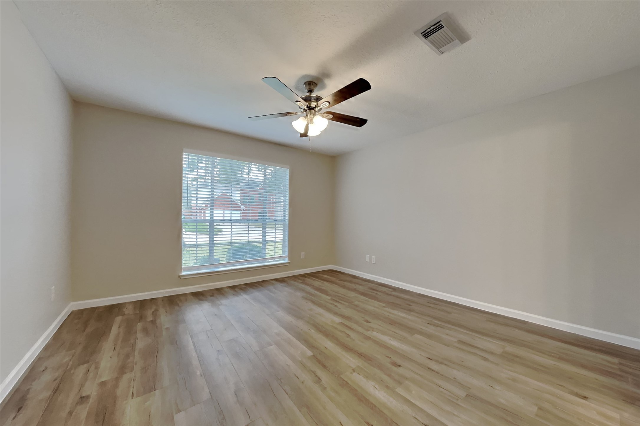 30806 Melita Drive Spring, TX 77386 - Photo 7 of 18 wooden floor in an empty room with a window