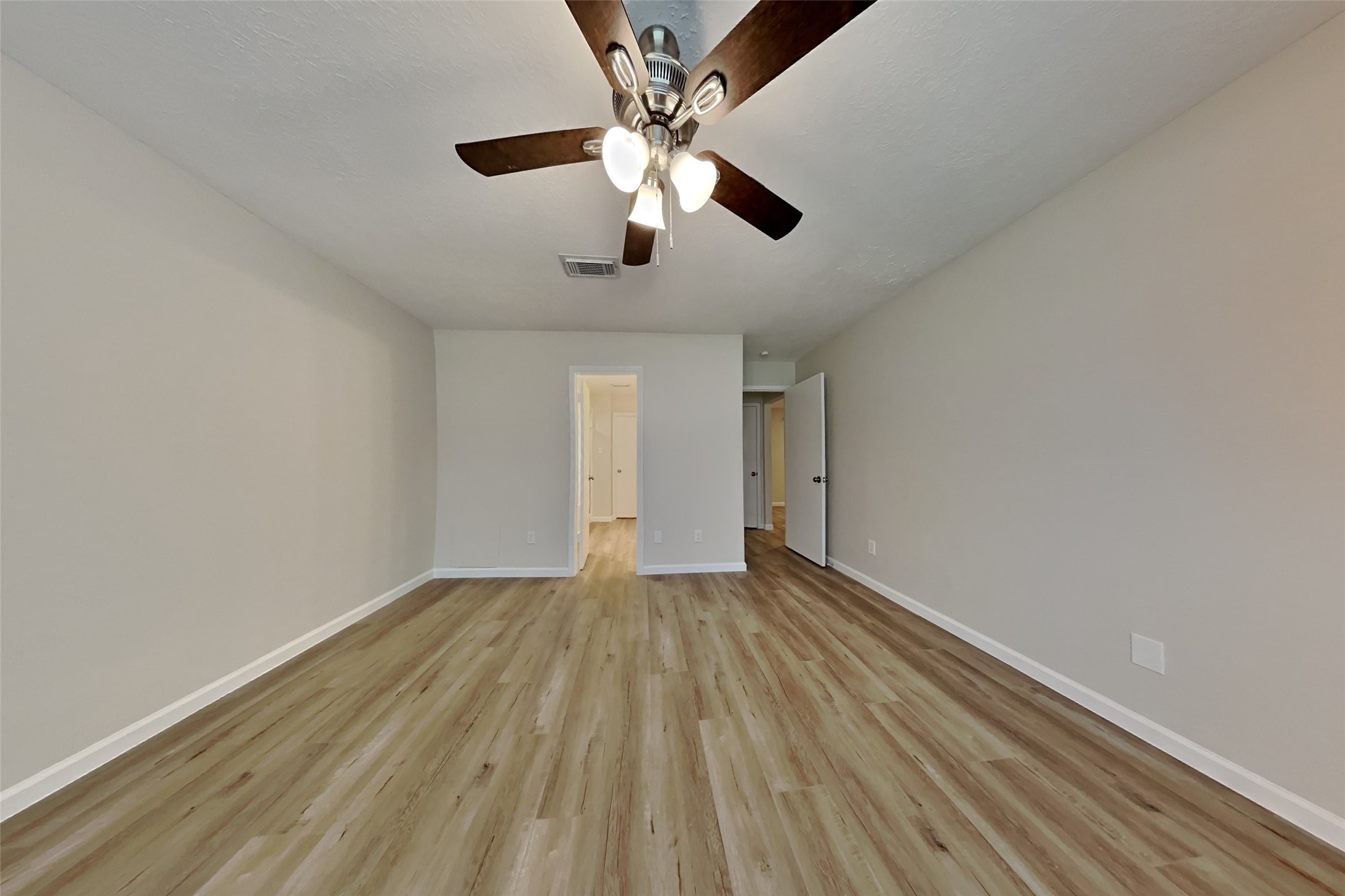 30806 Melita Drive Spring, TX 77386 - Photo 8 of 18 wooden floor in an empty room with a chandelier fan