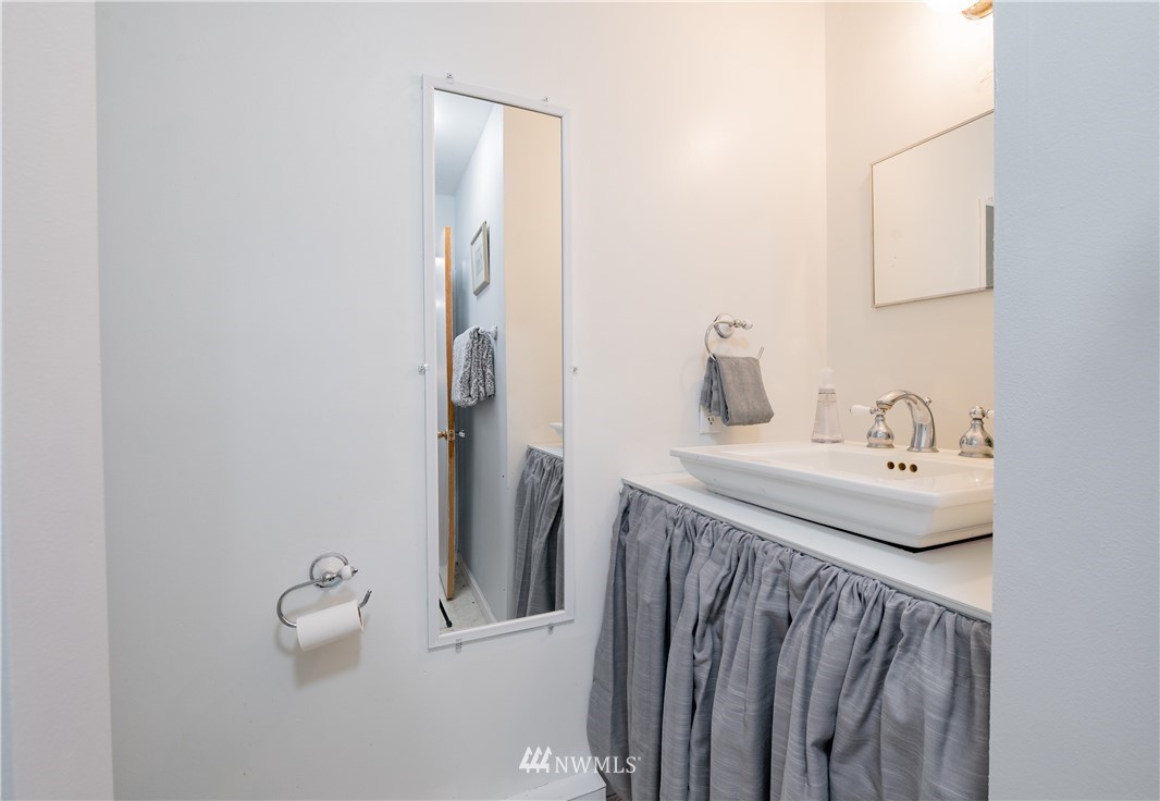 9641 Delta Line Road Blaine, WA 98230 - Photo 16 of 26 a bathroom with a sink and mirror