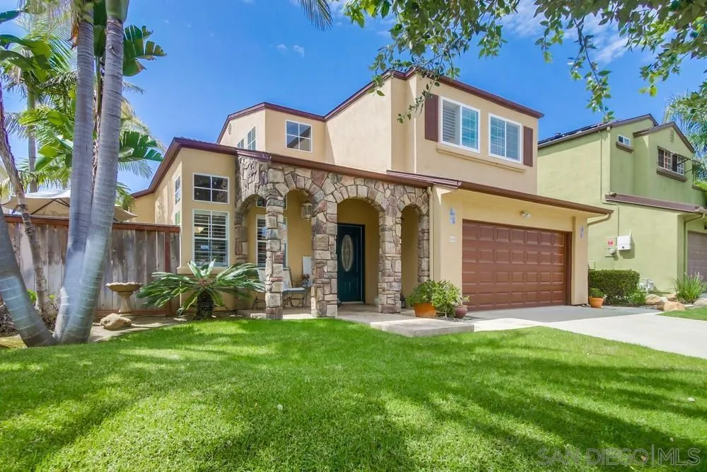 a front view of a house with a yard and pathway