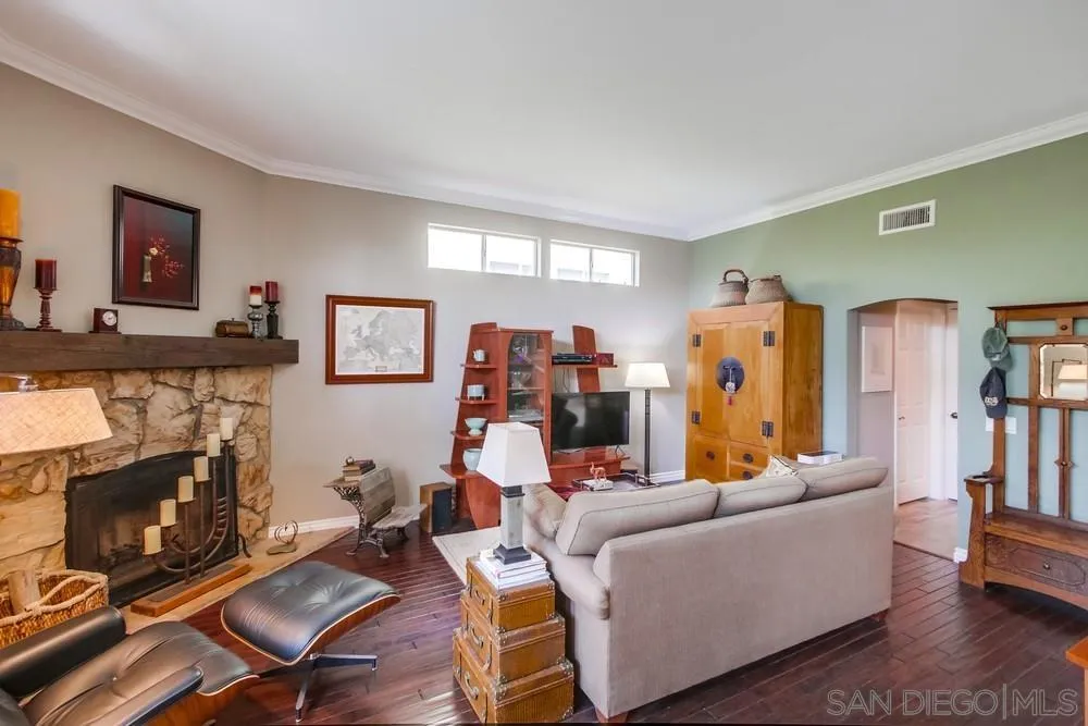 930 Gardena Road Encinitas, CA 92024 - Photo 12 of 40 a living room with furniture a flat screen tv and a fireplace