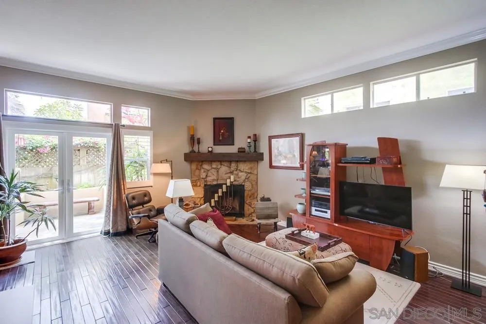 930 Gardena Road Encinitas, CA 92024 - Photo 13 of 40 a living room with furniture a flat screen tv and a floor to ceiling window