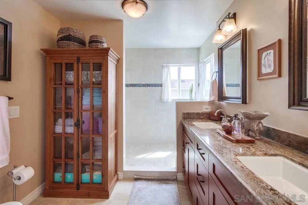 930 Gardena Road Encinitas, CA 92024 - Photo 23 of 40 a bathroom with a sink and a mirror
