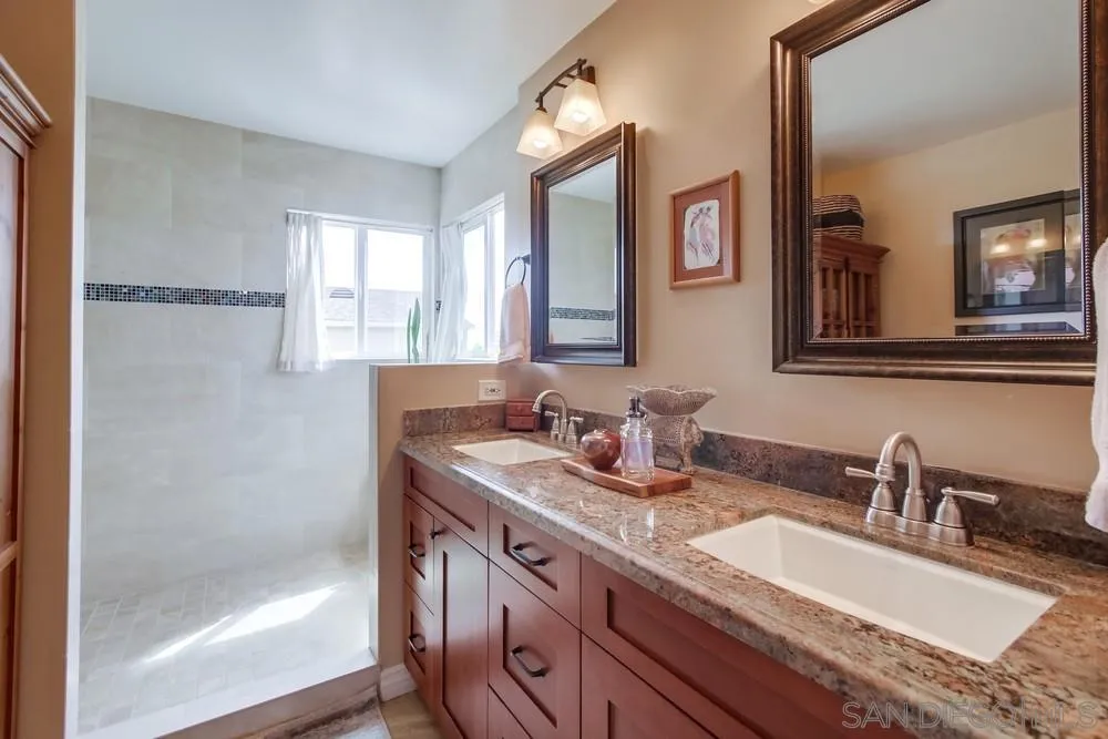 930 Gardena Road Encinitas, CA 92024 - Photo 24 of 40 a bathroom with a granite countertop sink mirror and double