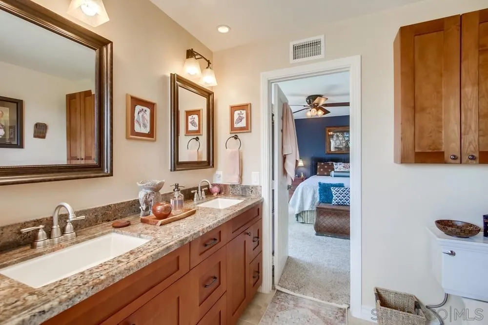 930 Gardena Road Encinitas, CA 92024 - Photo 25 of 40 a en suite bathroom with double vanity sinks and a mirror
