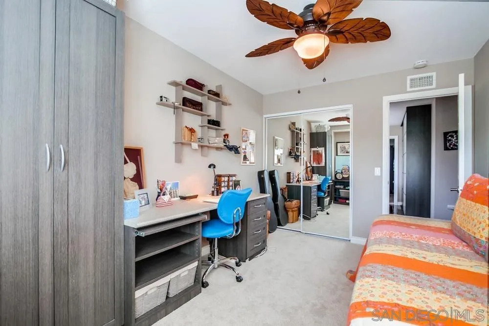 930 Gardena Road Encinitas, CA 92024 - Photo 33 of 40 a bedroom with a bed and a chandelier