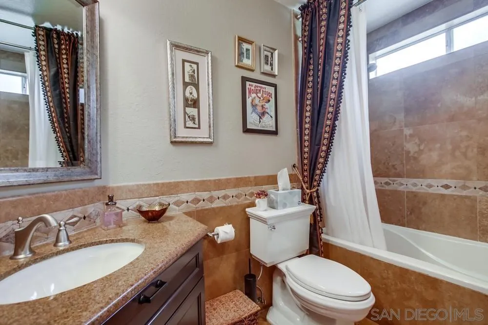 930 Gardena Road Encinitas, CA 92024 - Photo 34 of 40 a bathroom with a granite countertop toilet sink and mirror
