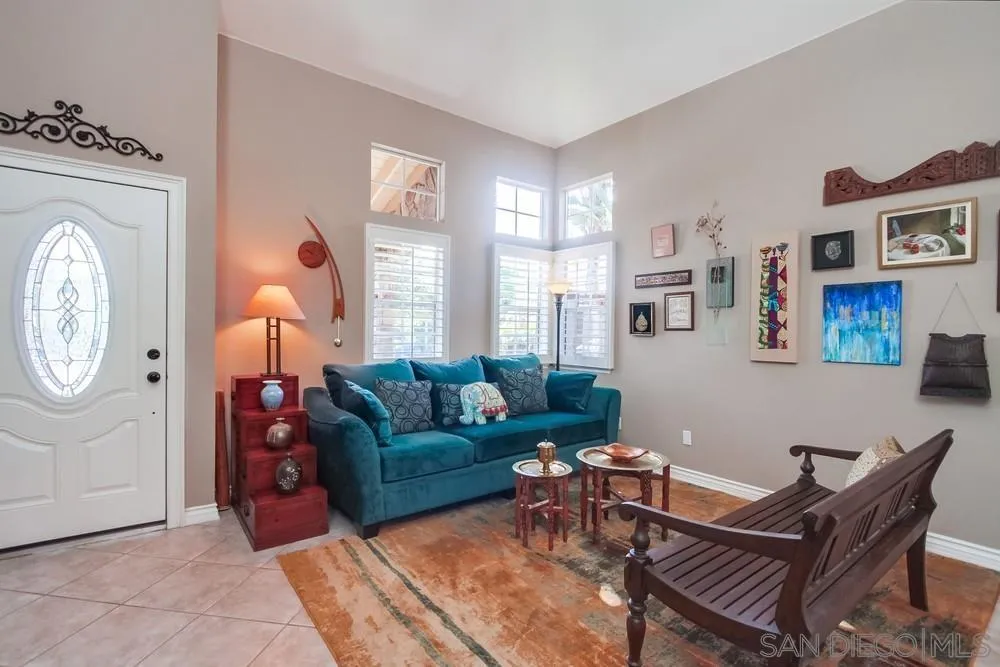 930 Gardena Road Encinitas, CA 92024 - Photo 5 of 40 a living room with furniture a clock on wall and a window