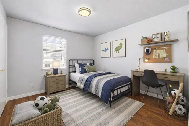 a bed room with a bed and a chair