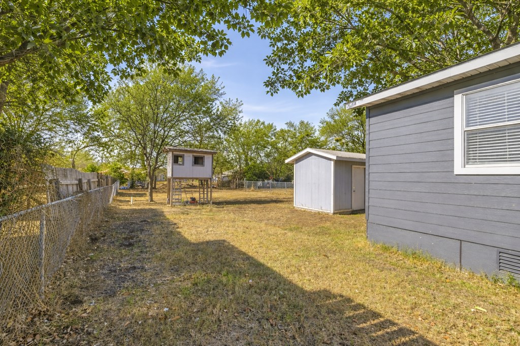 213 West Davis Street Kerrville, TX 78028 - Photo 16 of 17 a front view of a house with a yard and garage