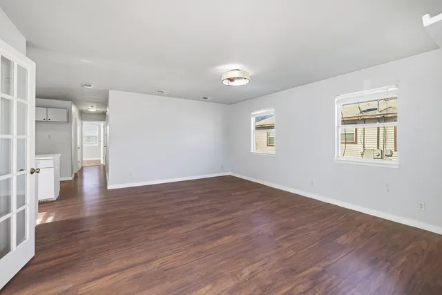 wooden floor in an empty room with a window