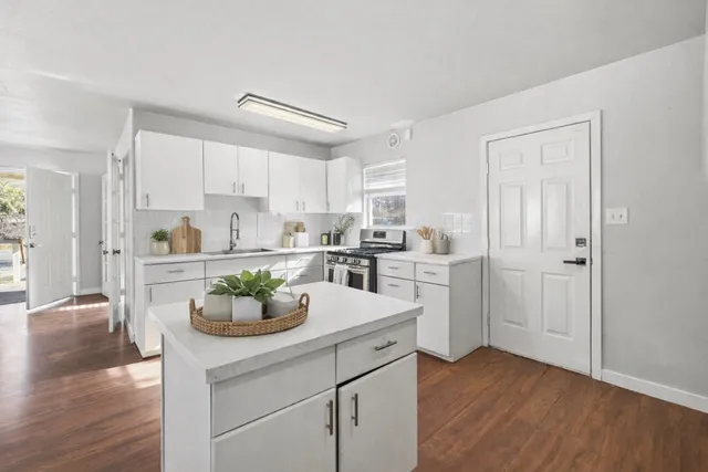 a kitchen with a sink cabinets stainless steel appliances and cabinets