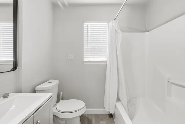 a white toilet sitting next to a bathroom sink