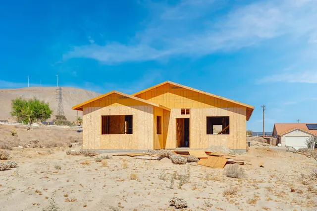 a view of a hallway with wooden floor and entryway