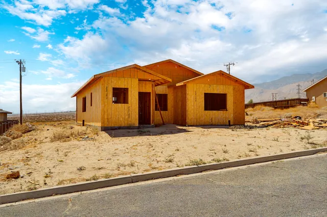 a blue and white house covered in snow