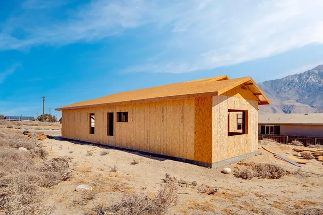 a backyard of a house with snow on the road