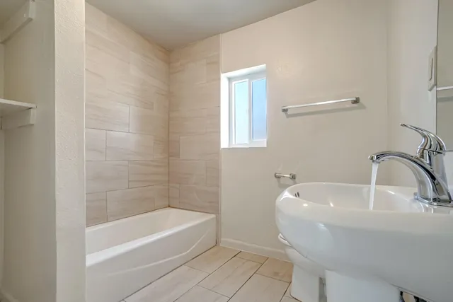 a bathroom with a sink toilet and a mirror