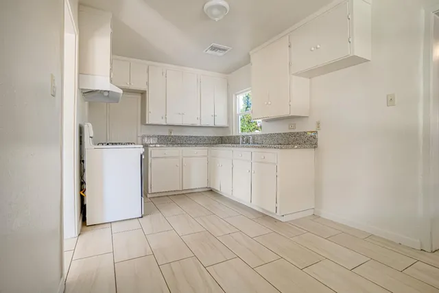 a kitchen with a stove a sink and a refrigerator