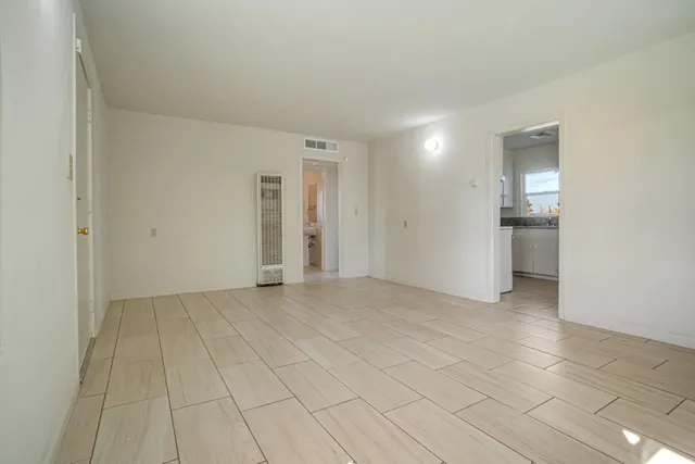 a view of an empty room with glass door