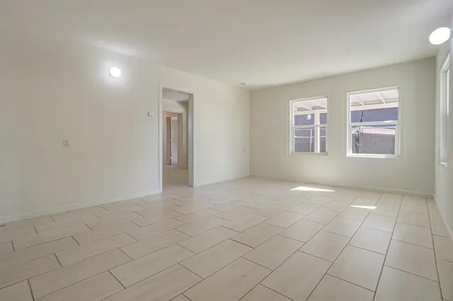 an empty room with windows and closet