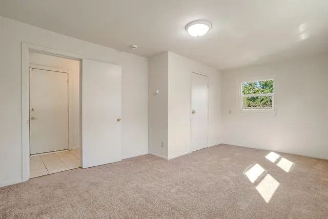 a view of an empty room with a window