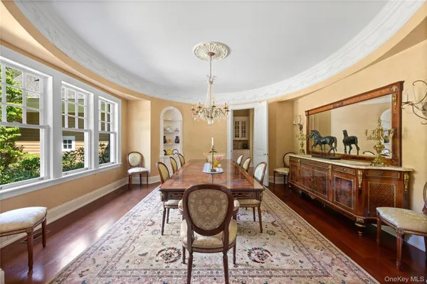 a living room with furniture a window and a chandelier