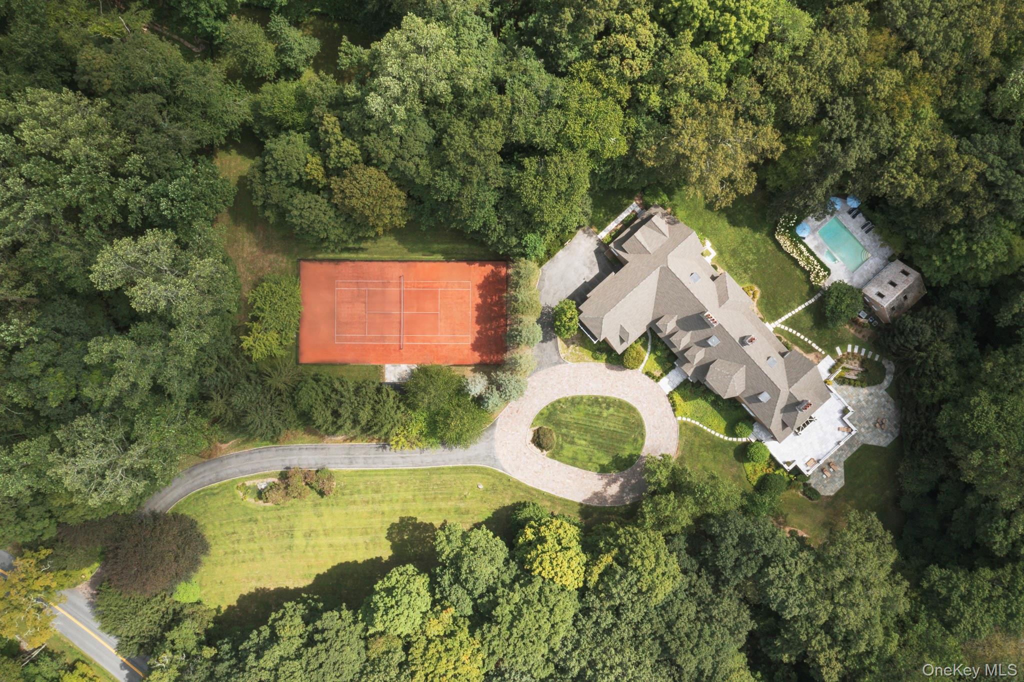 284 West Patent Road Bedford, NY 10549 - Photo 4 of 40 an aerial view of a house with swimming pool and trees