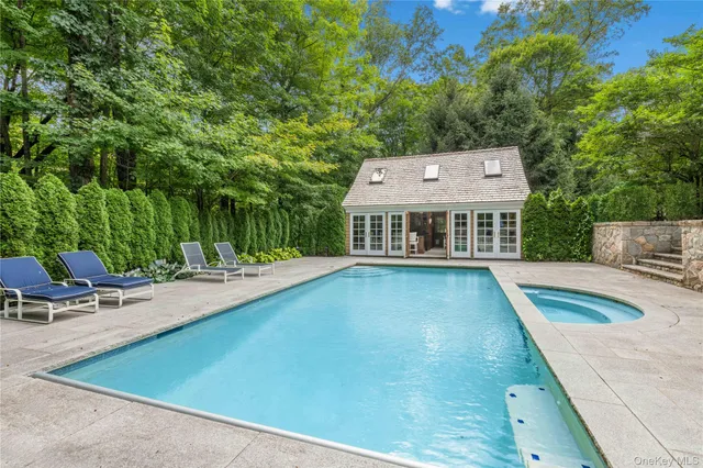 swimming pool view with a seating space