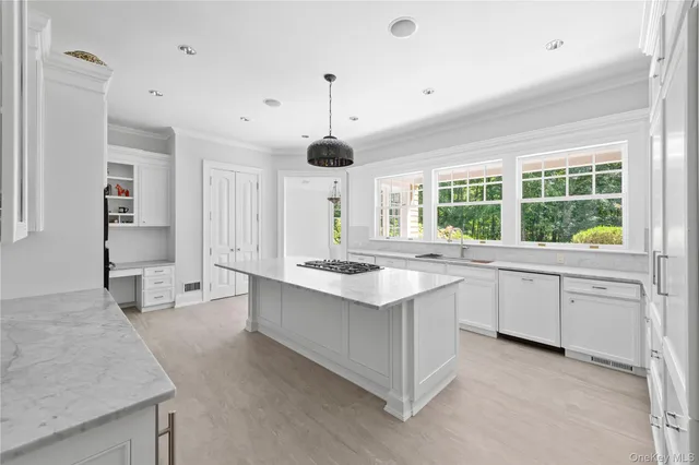 a kitchen with granite countertop a sink stove and cabinets