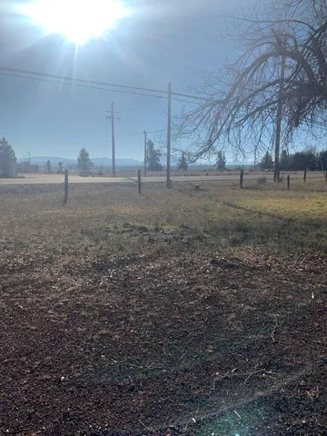 a view of a yard with cars