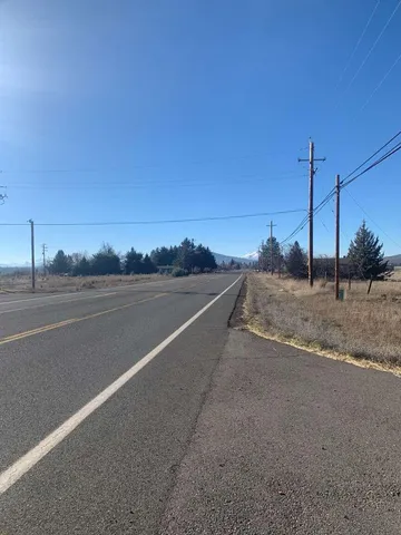 a view of a yard with wooden fence