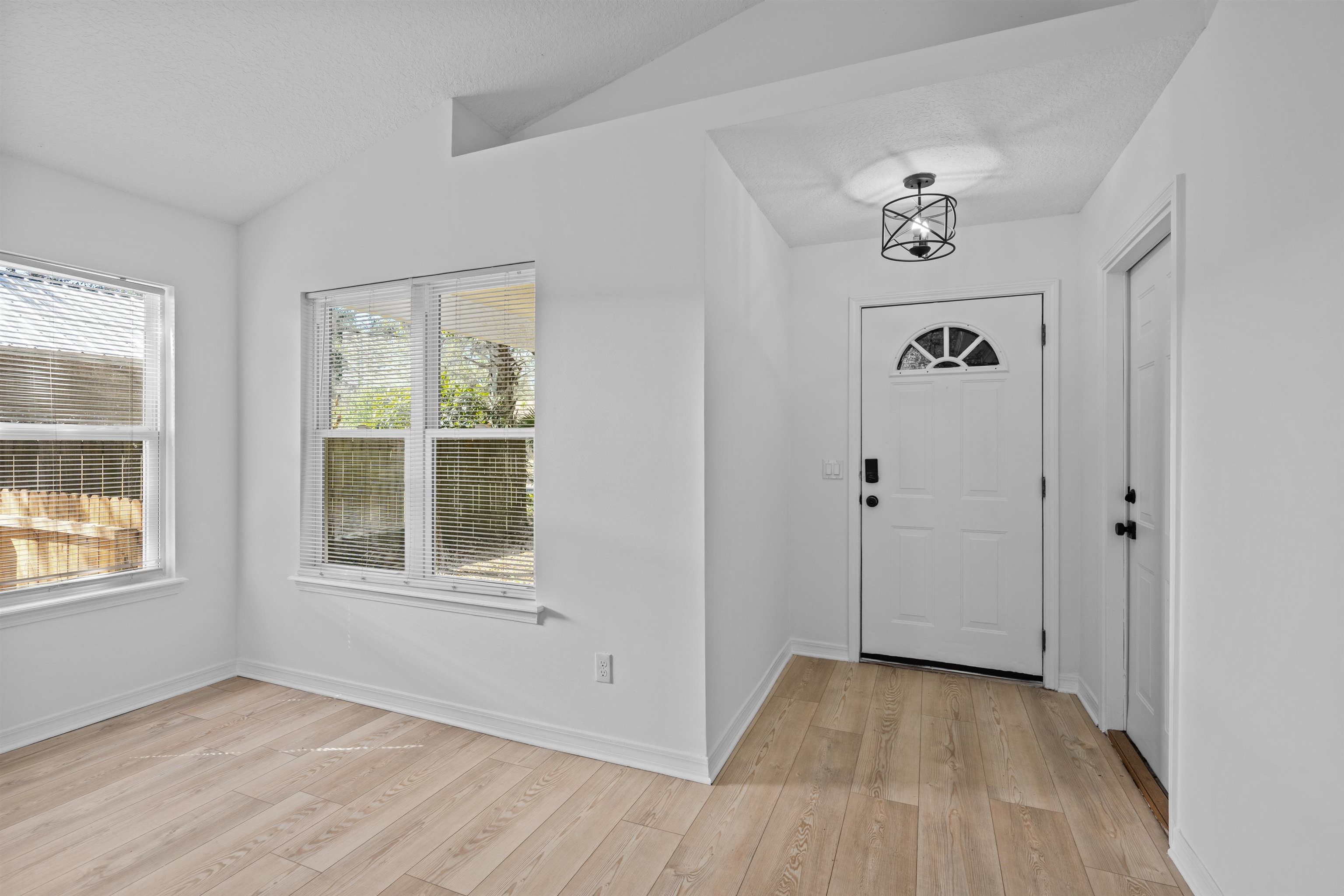 236 Nesmith Avenue St. Augustine, FL 32084 - Photo 8 of 40 an empty room with wooden floor and windows
