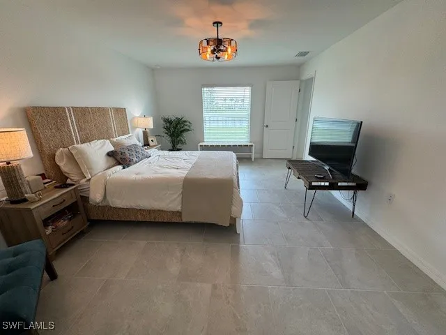 a bedroom with a bed and window