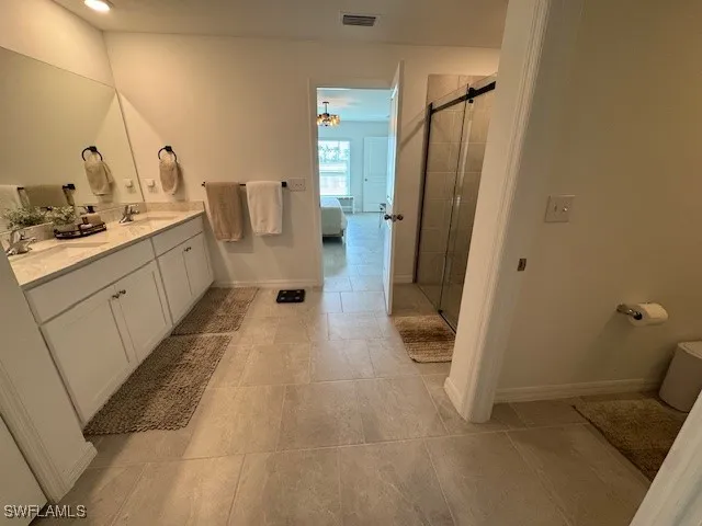 a bathroom with sink a mirror and shower