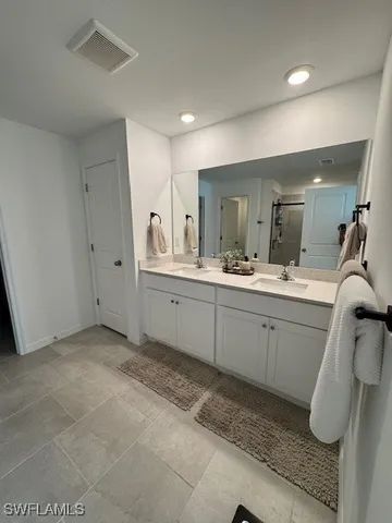 a spacious bathroom with a mirror sink and vanity