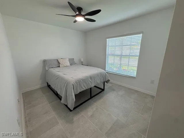 a bed sitting in a room next to a window