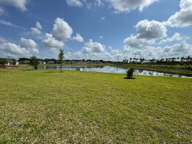 a view of a lake with houses in back