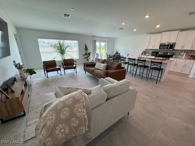 a living room with furniture and a large window
