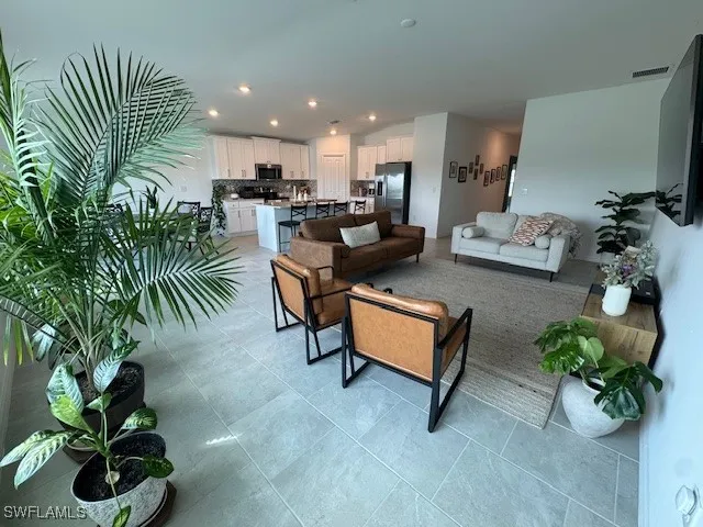 a living room with furniture and a potted plant