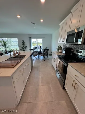 a kitchen with sink cabinets and microwave